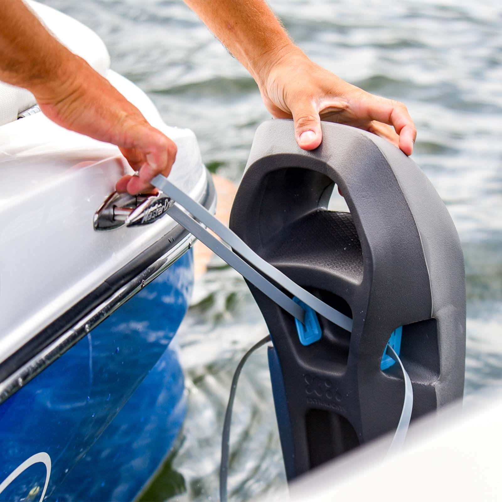 A person is putting a MISSION Sentry Boat Fender on the side of a boat for protection using Boat fenders.