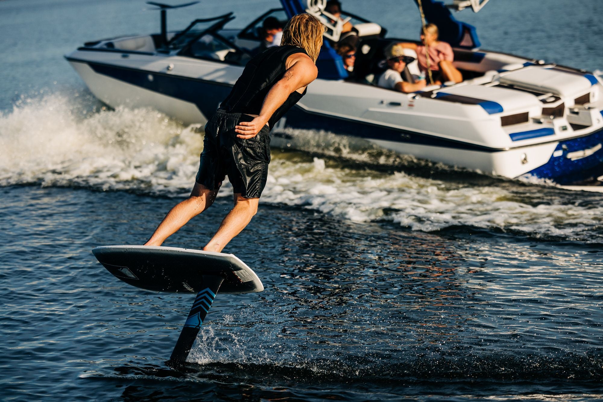 A man is riding a wakeboard on a Liquid Force 2024 Orb Foil Board.