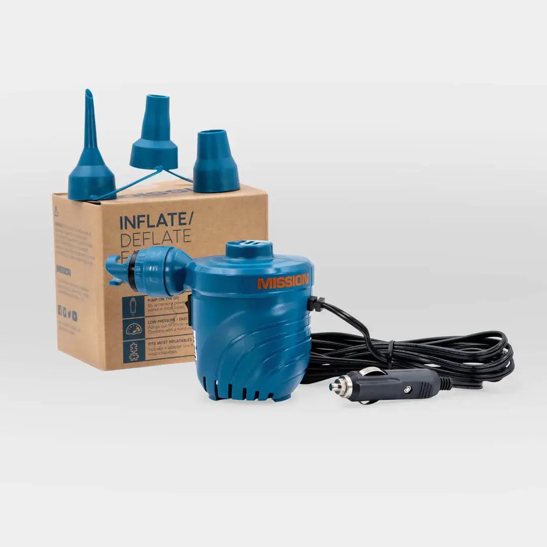 The MISSION 12V DC Low Pressure Pump is in front of a box, powered by a MISSION 12v accessory power adapter.