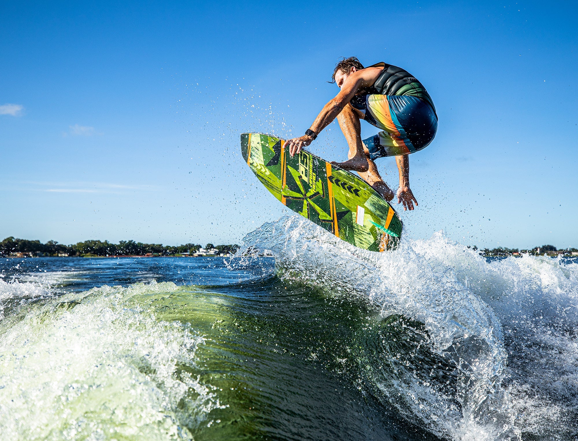 A maneuverable man is riding a wave on a Phase 5 2023 Hammerhead Wakesurf Board using skim style.