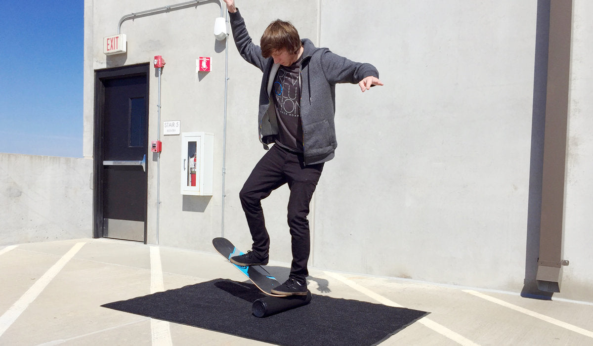 A young man showcasing impressive tricks and progression on a Revolution Core 32 Balance Board skateboard.