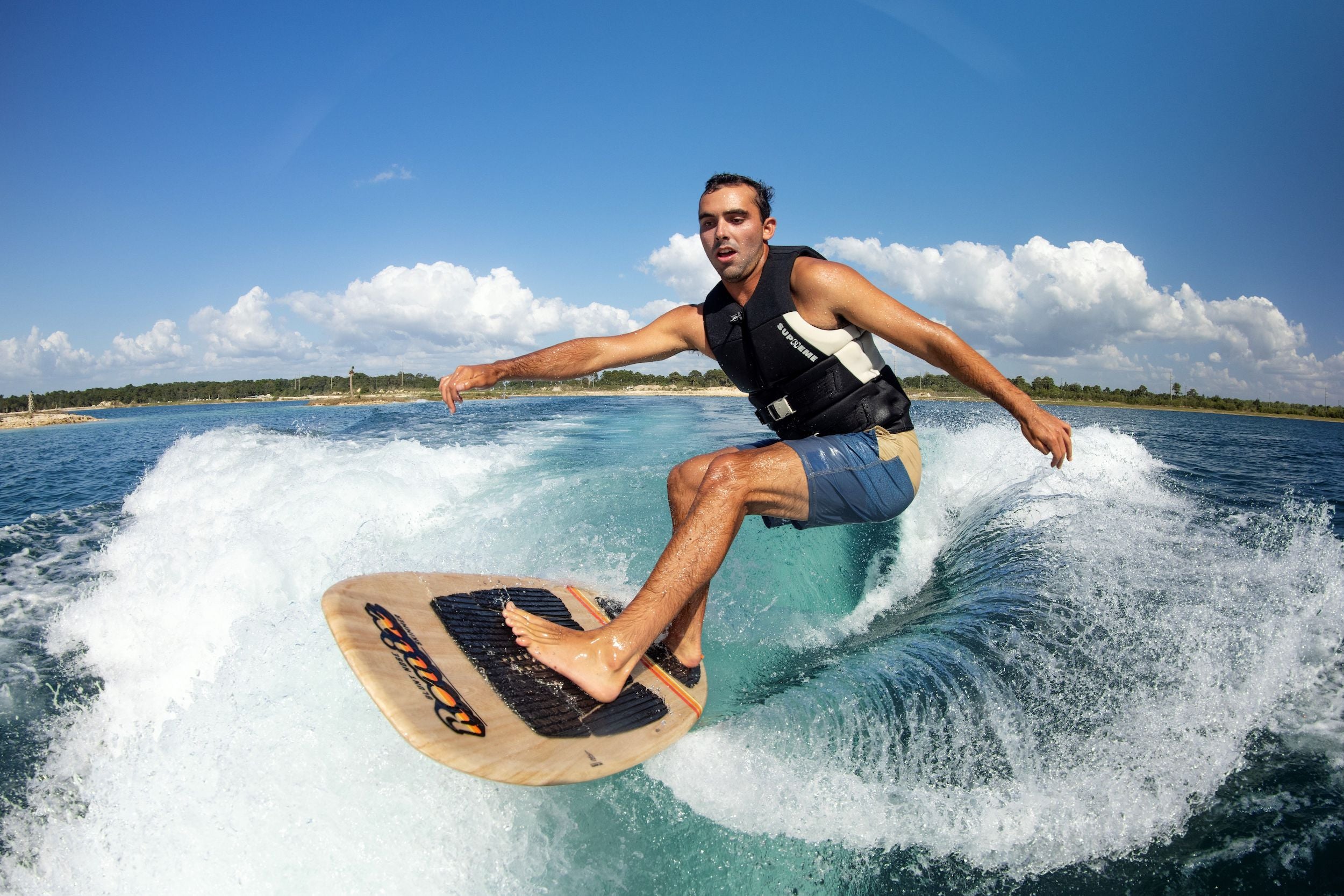 A man riding a wave on a Ronix 2024 Element Core Blunt Nose Skimmer.