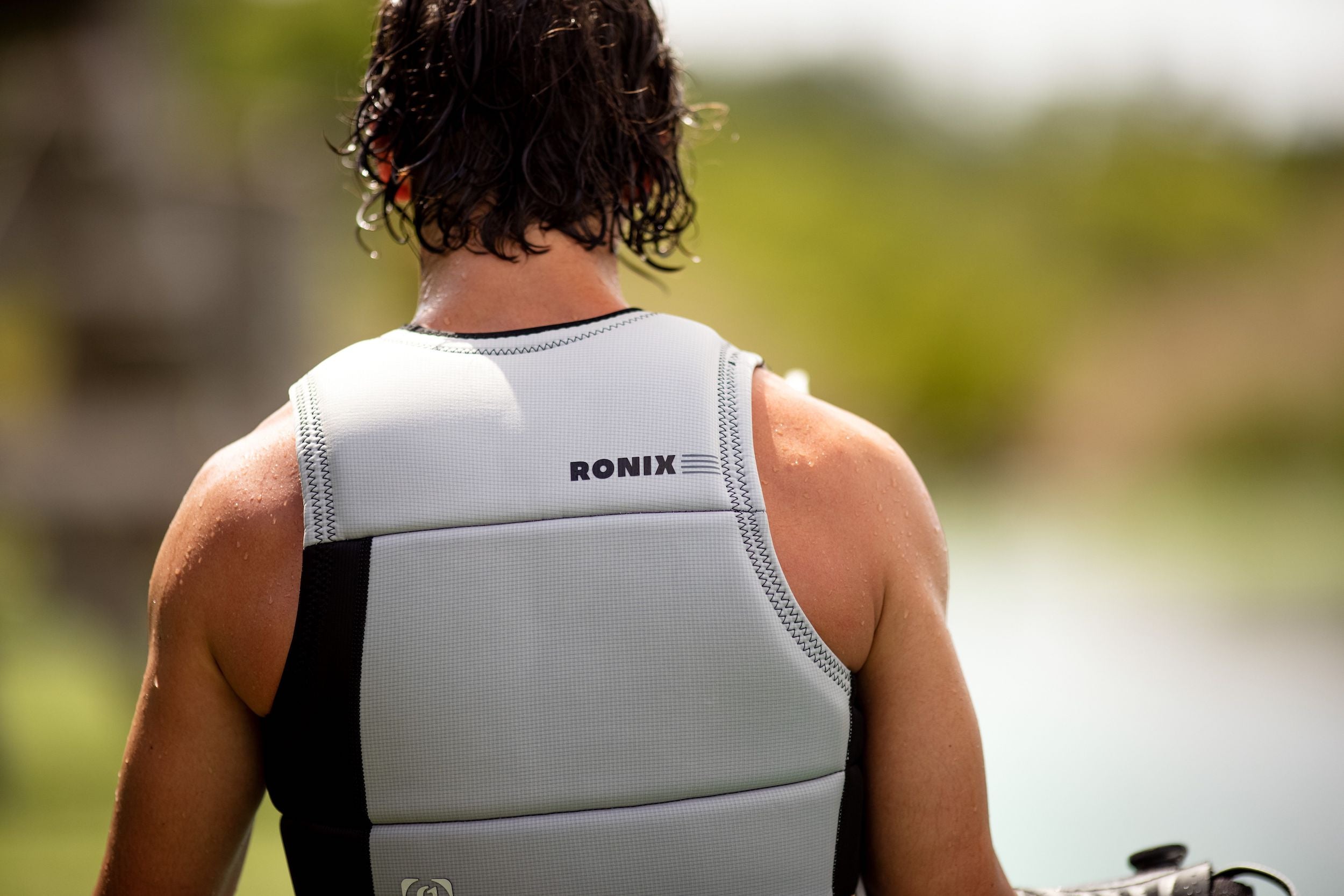 The impact of a properly sized Ronix 2024 Supreme CE Approved Impact Vest on the back of a man.